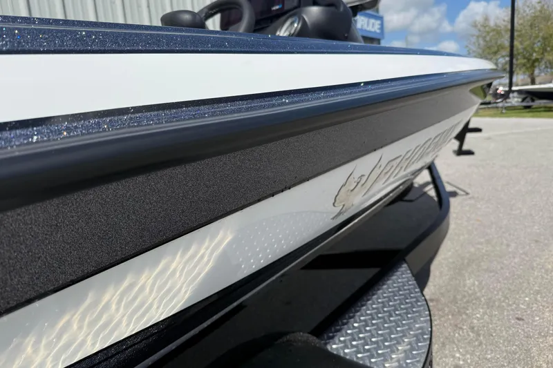 Slide: The Image of 2025 Phoenix 819 ZXL boat side view with sleek design and logo detail. - 4