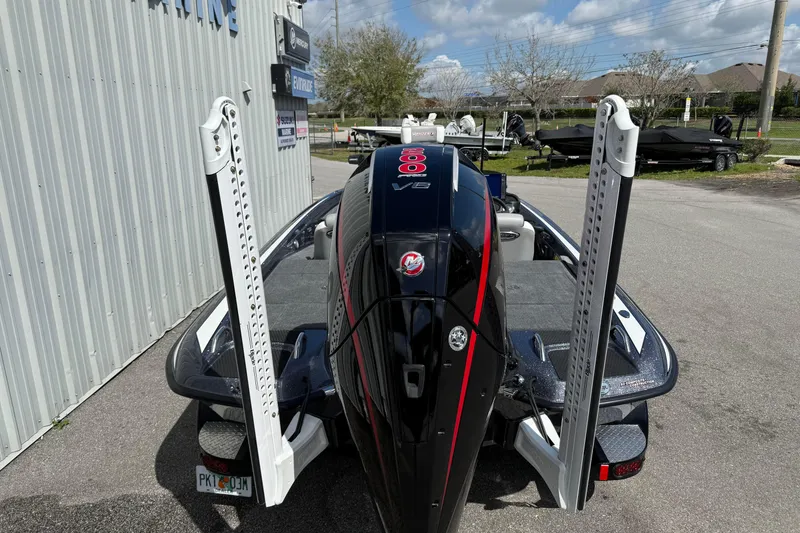 Slide: The Image of 2025 Phoenix 819 ZXL boat with powerful engine, parked outdoors near a marine facility. - 5