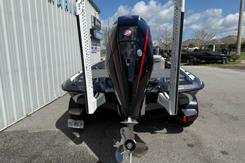 Slide: The Image of 2025 Phoenix 819 ZXL boat with powerful outboard motor, parked outdoors. - 6