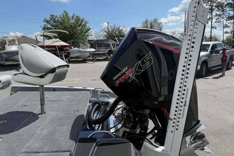 Slide: The Image of 2025 Phoenix 819 ZXL boat with Mercury Pro XS engine in a marina setting. - 7