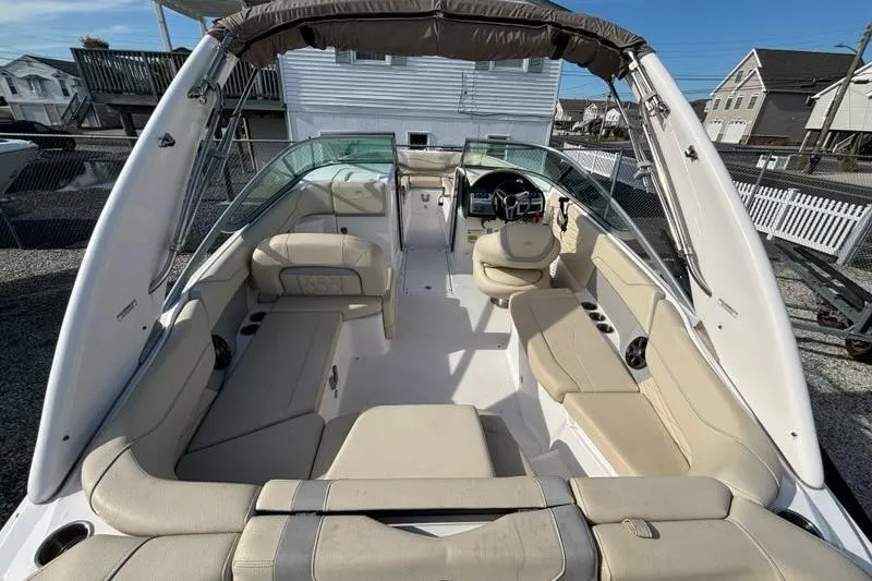 Slide: The Image of 2021 Regal 23 OBX boat interior with beige seating and modern dashboard. - 11