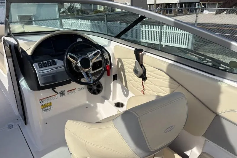 Slide: The Image of 2021 Regal 23 OBX boat interior with steering wheel and beige seating. - 15