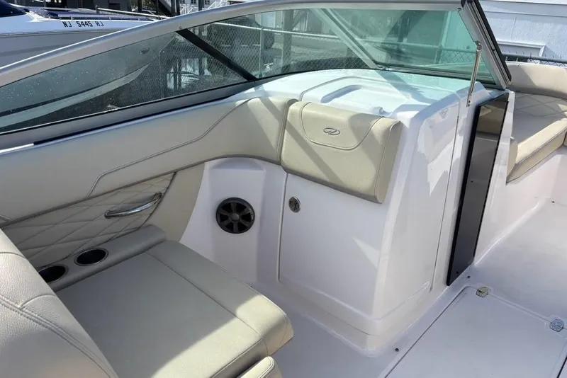 Slide: The Image of 2021 Regal 23 OBX boat interior with beige seating and modern design. - 16