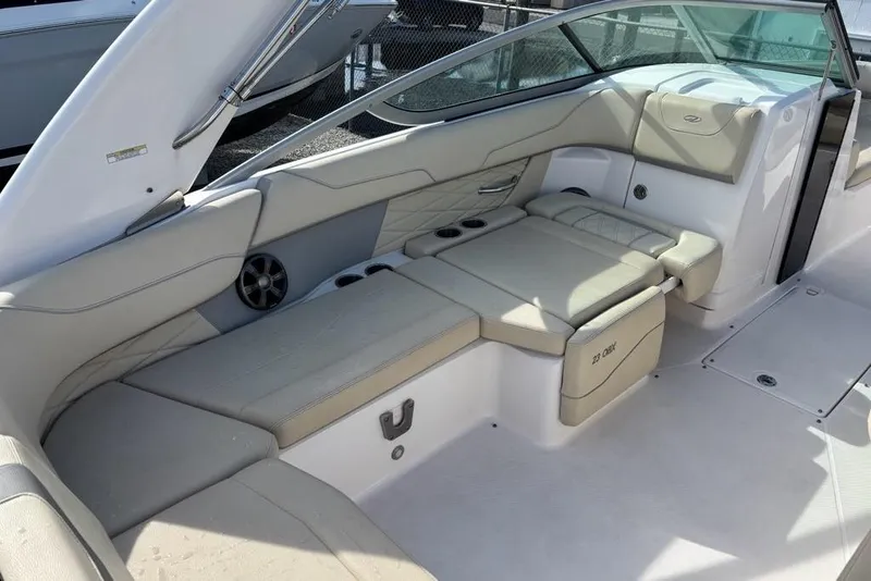 Slide: The Image of 2021 Regal 23 OBX boat interior with beige seating and cup holders. - 17