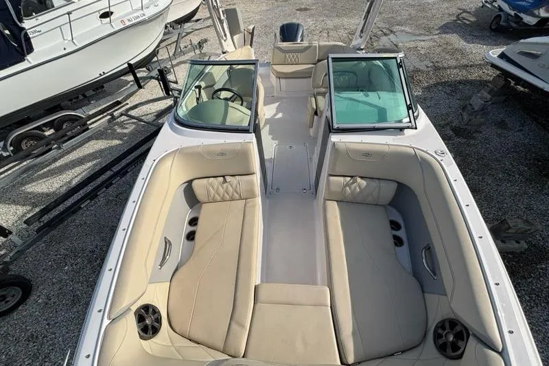 Slide: The Image of 2021 Regal 23 OBX boat with beige seating and open deck layout. - 18