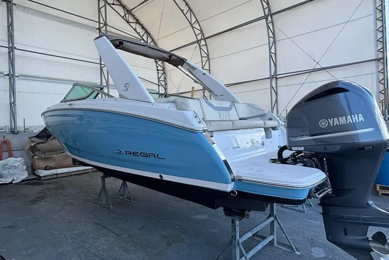 Slide: The Image of 2021 Regal 23 OBX boat with Yamaha outboard motor in storage facility. - 5