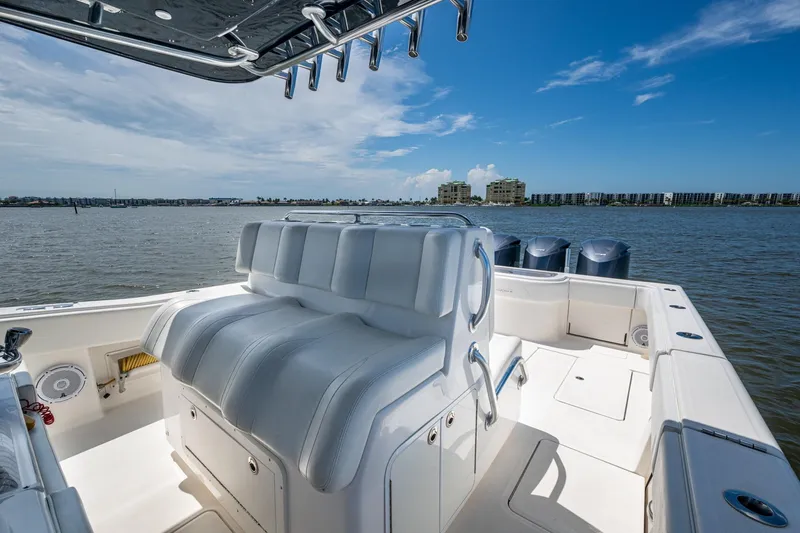 Slide: The Image of 2015 Invincible 42 Open Fisherman boat interior with seating, ocean view, and clear sky. - 12