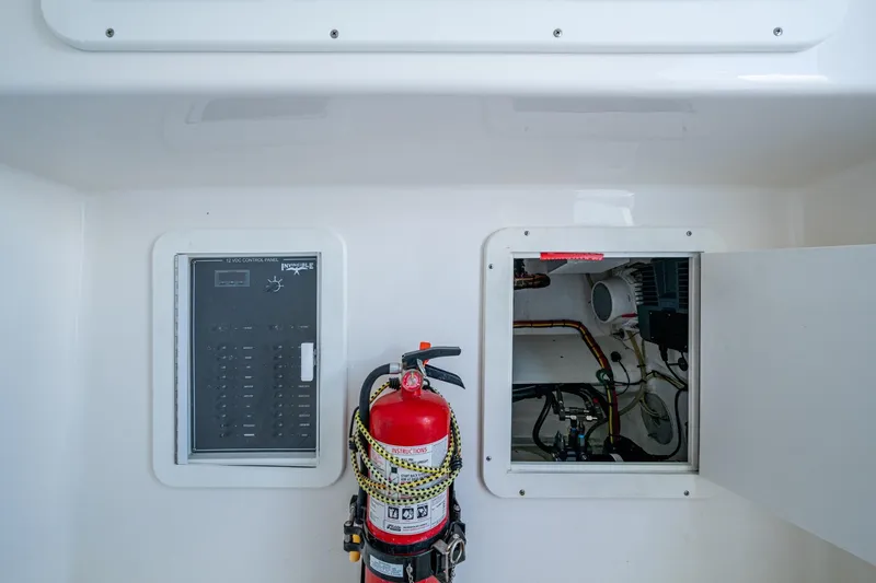Slide: The Image of Electrical panel and fire extinguisher on 2015 Invincible 42 Open Fisherman boat. - 16