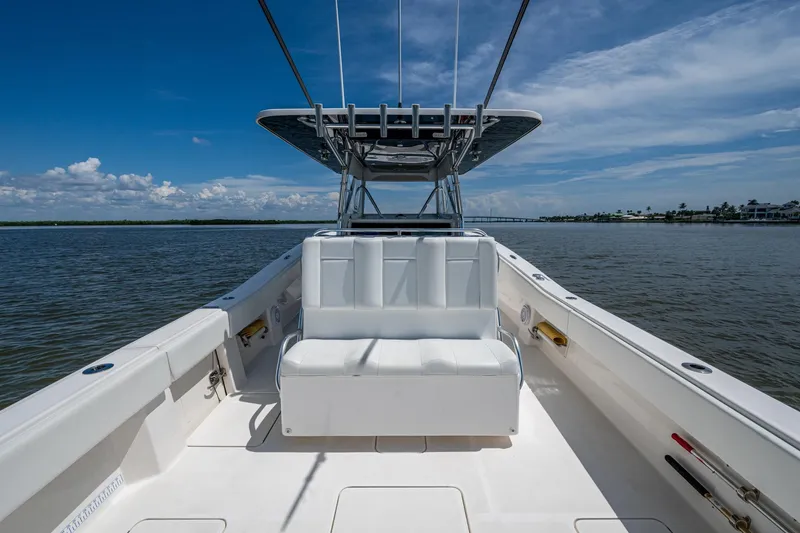 Slide: The Image of 2015 Invincible 42 Open Fisherman boat on calm water under a clear blue sky. - 17