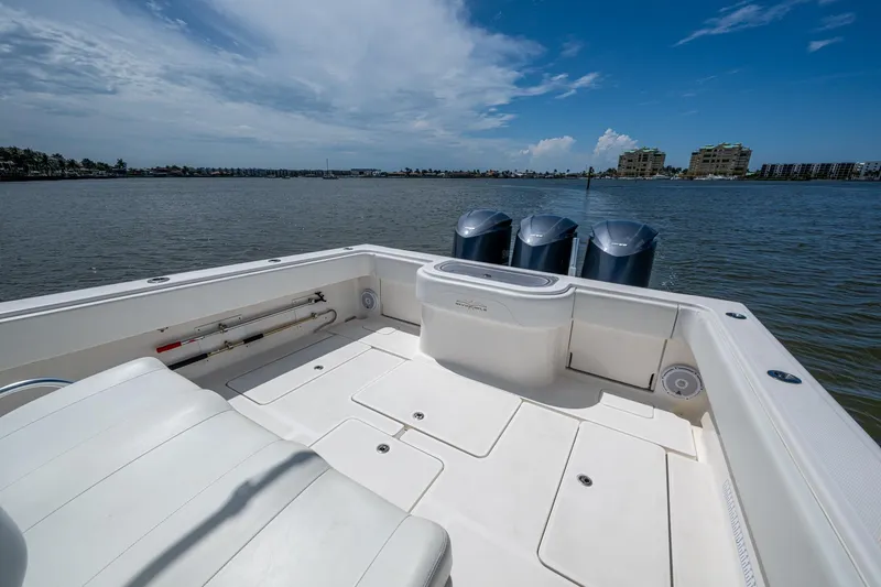 Slide: The Image of 2015 Invincible 42 Open Fisherman boat with triple engines on calm water. - 21