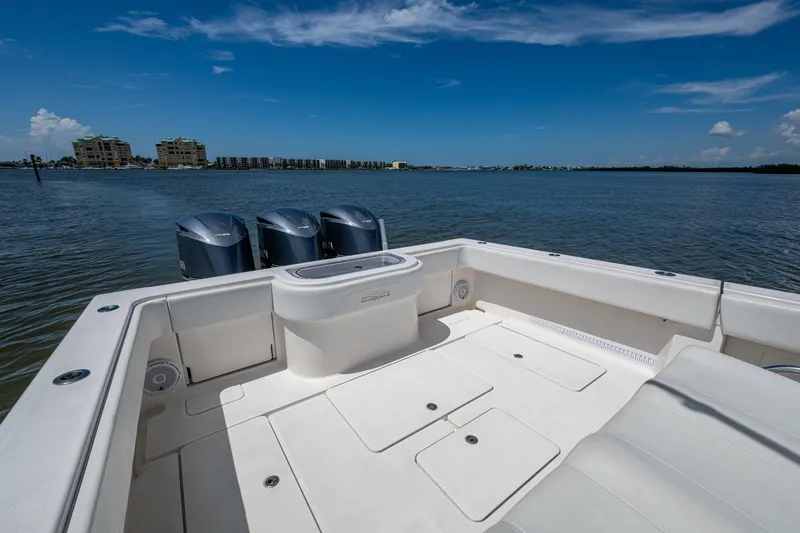 Slide: The Image of 2015 Invincible 42 Open Fisherman boat with triple engines on calm water. - 22