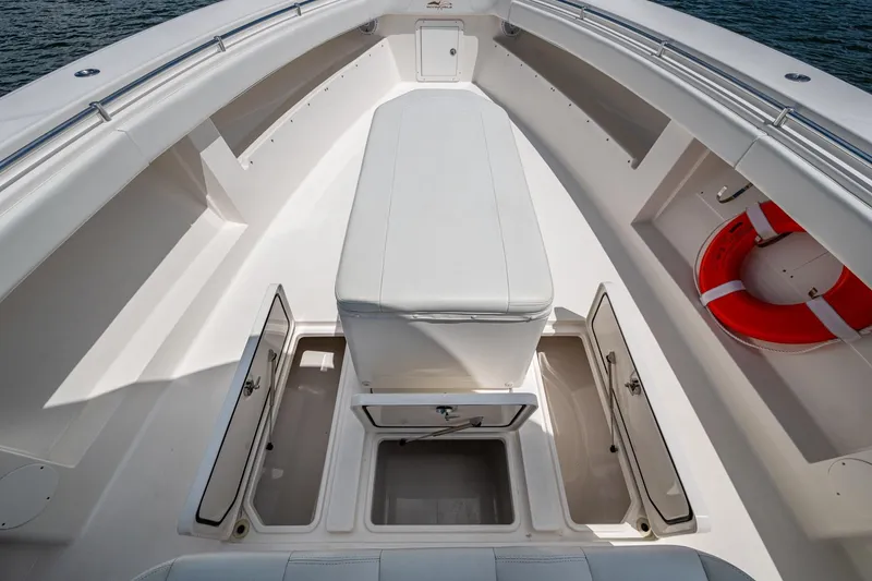 Slide: The Image of 2015 Invincible 42 Open Fisherman boat interior with storage compartments and life preserver. - 26
