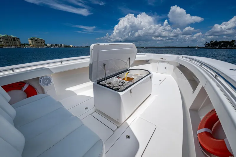 Slide: The Image of 2015 Invincible 42 Open Fisherman boat with open storage, white seating, and ocean view. - 28
