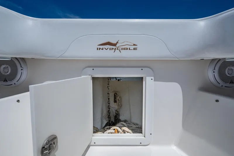 Slide: The Image of 2015 Invincible 42 Open Fisherman boat anchor compartment with open hatch and visible chain. - 29