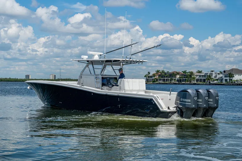 Slide: The Image of 2015 Invincible 42 Open Fisherman boat cruising on a sunny day with Yamaha engines. - 3