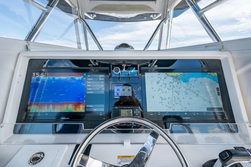 Slide: The Image of Control panel of 2015 Invincible 42 Open Fisherman with dual Garmin displays. - 7