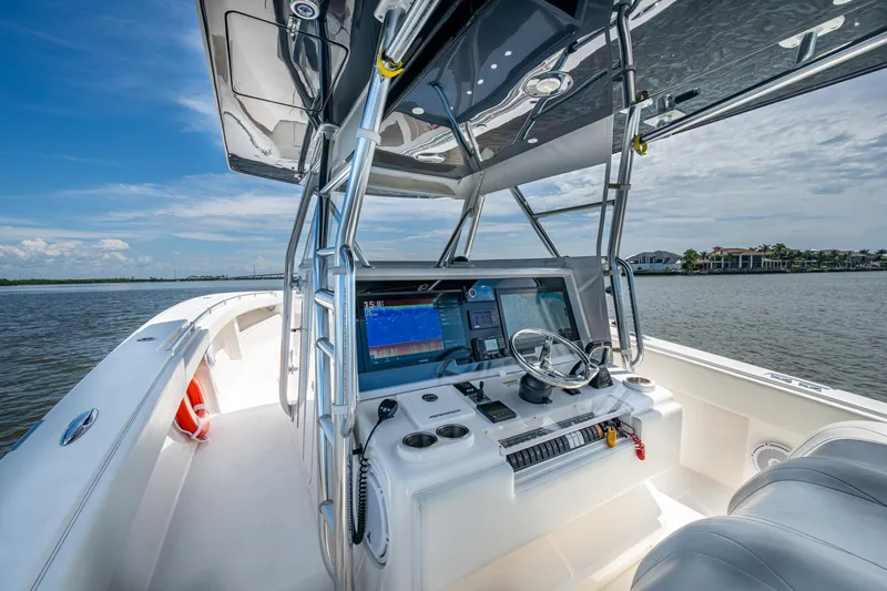 Slide: The Image of 2015 Invincible 42 Open Fisherman boat cockpit with navigation equipment on a sunny day. - 8