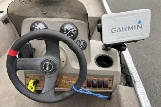 Slide: The Image of 2002 Tracker Pro Team 165 boat dashboard with Garmin GPS and steering wheel. - 16
