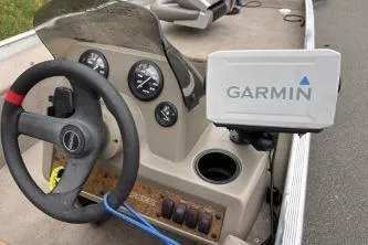 Slide: The Image of 2002 Tracker Pro Team 165 boat dashboard with Garmin navigation system. - 17