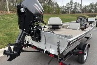 Slide: The Image of 2002 Tracker Pro Team 165 boat with Mercury outboard motor on a trailer. - 18