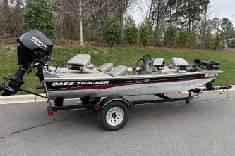 Slide: The Image of 2002 Tracker Pro Team 165 bass boat on trailer, parked outdoors. - 19