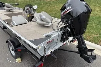 Slide: The Image of 2002 Tracker Pro Team 165 boat with Mercury outboard motor on a trailer. - 3