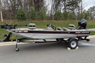 Slide: The Image of 2002 Tracker Pro Team 165 fishing boat on trailer, parked on roadside. - 6
