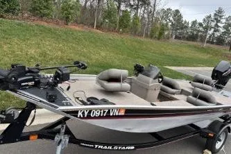 Slide: The Image of 2002 Tracker Pro Team 165 fishing boat on trailer, parked on roadside. - 8