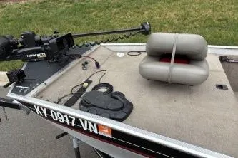 Slide: The Image of 2002 Tracker Pro Team 165 boat with trolling motor and cushioned seat on deck. - 9