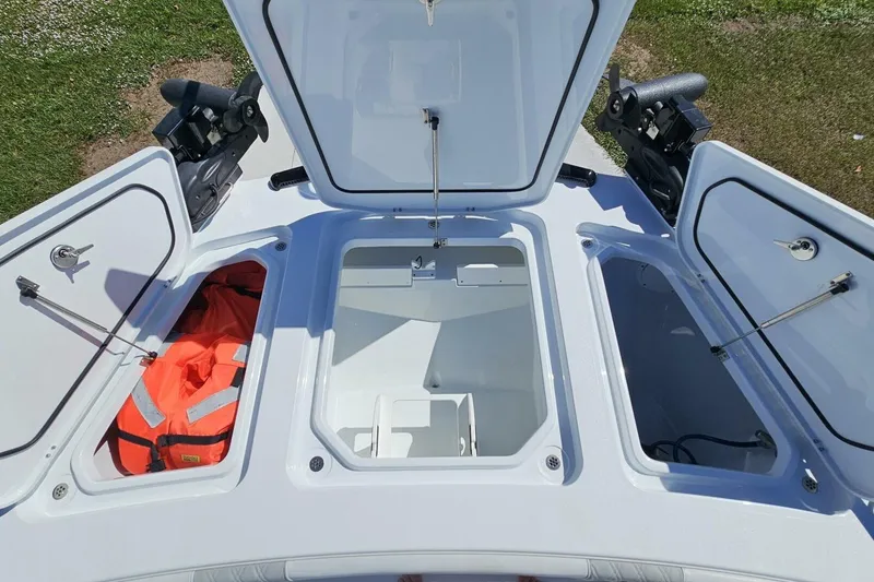 Slide: The Image of 2025 Costa Custom Boats 34ST storage compartments with open hatches and safety gear. - 19