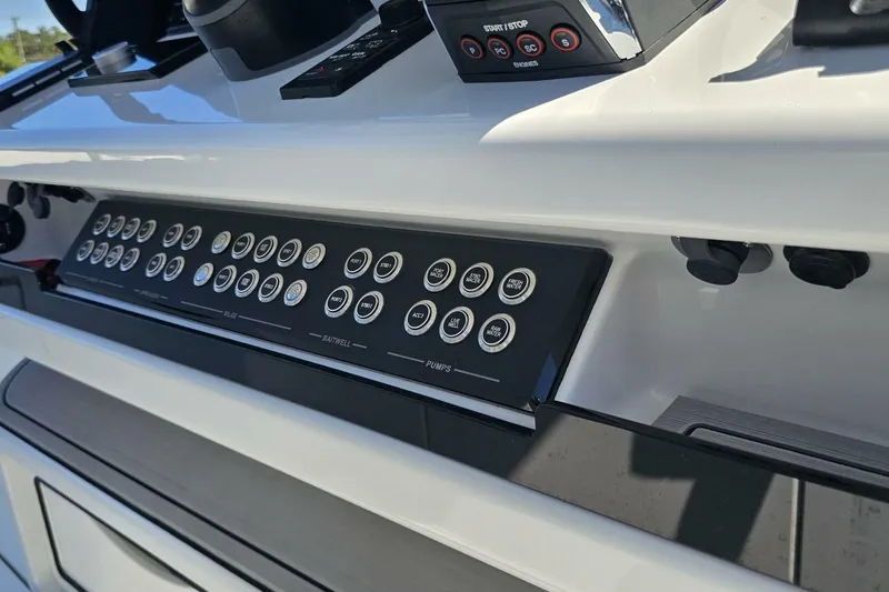 Slide: The Image of Control panel of 2025 Costa Custom Boats 34ST, featuring multiple buttons and switches. - 37