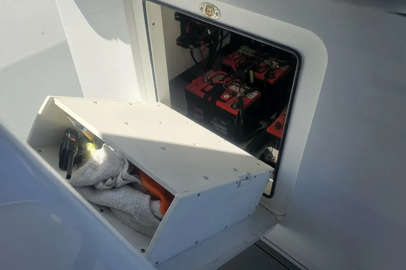 Slide: The Image of Storage compartment with tools and batteries on a 2025 Costa Custom Boats 34ST. - 38