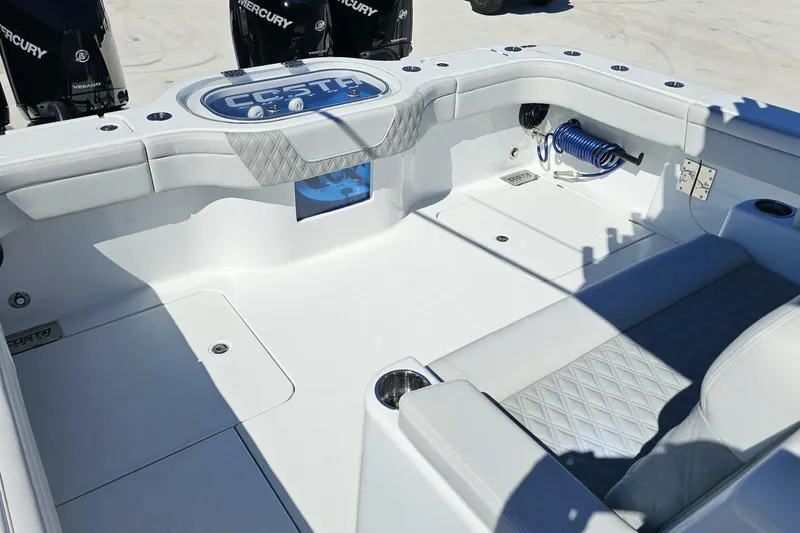 Slide: The Image of 2025 Costa Custom Boats 34ST interior with seating and storage, featuring Mercury engines. - 40