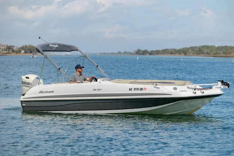 The Image of 2019 Hurricane SunDeck Sport 201 OB boat cruising on a calm lake. - 0