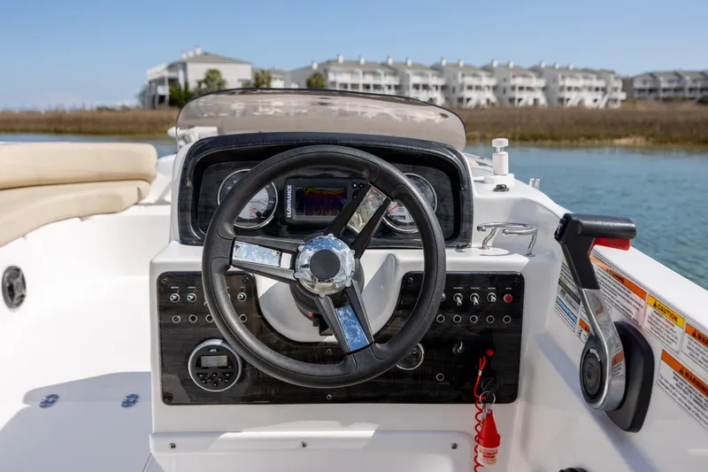 Slide: The Image of 2019 Hurricane SunDeck Sport 201 OB boat dashboard with steering wheel and controls. - 12