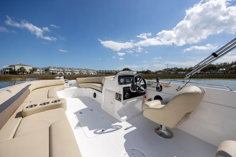 Slide: The Image of 2019 Hurricane SunDeck Sport 201 OB boat interior with beige seating and steering console. - 14