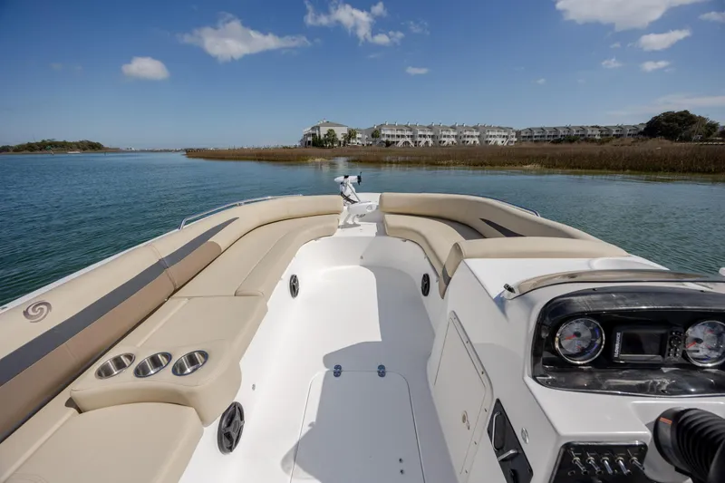 Slide: The Image of 2019 Hurricane SunDeck Sport 201 OB boat interior with beige seating, on calm water. - 15