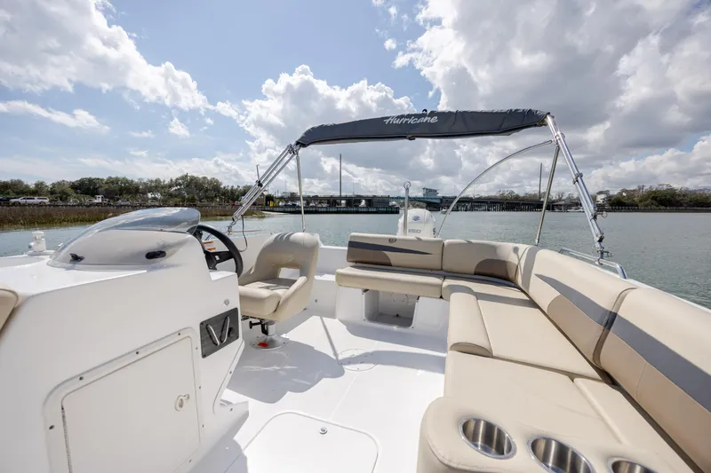 Slide: The Image of 2019 Hurricane SunDeck Sport 201 OB boat with spacious seating and canopy on a sunny day. - 20