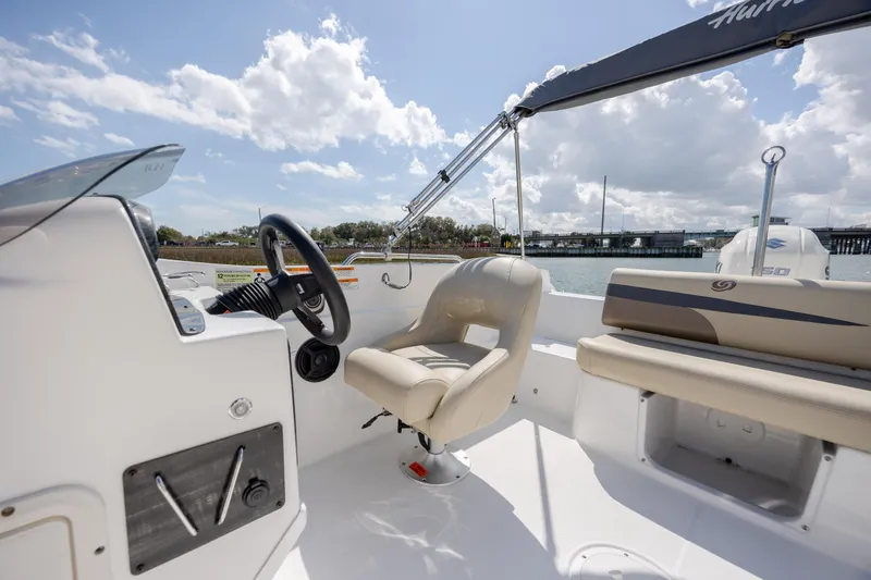 Slide: The Image of 2019 Hurricane SunDeck Sport 201 OB boat interior with steering wheel and seating. - 21