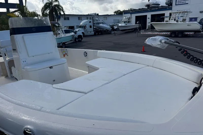 Slide: The Image of 2025 Skeeter SX2350 boat interior with seating, parked at a marina with other boats. - 6