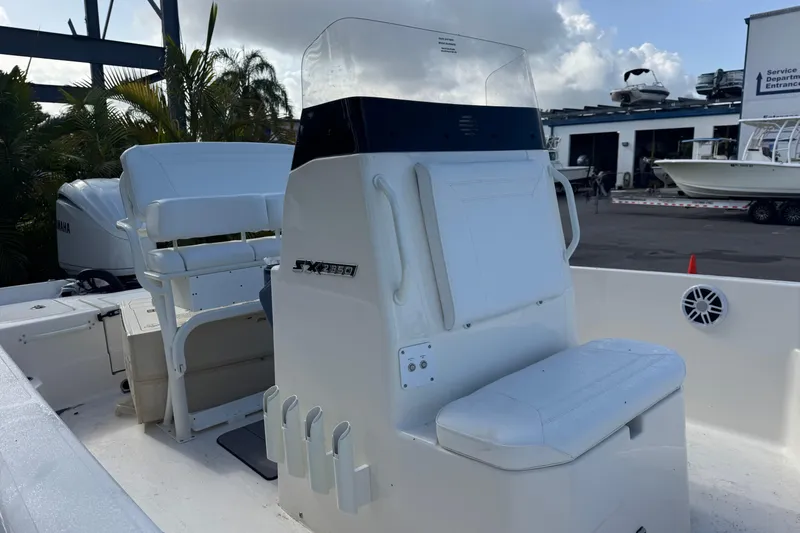 Slide: The Image of 2025 Skeeter SX2350 boat interior with seating and console, parked at a marina. - 8