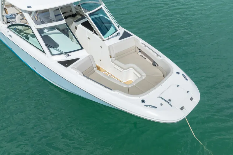 Slide: The Image of 2018 Boston Whaler 320 Vantage boat on clear turquoise water. - 10