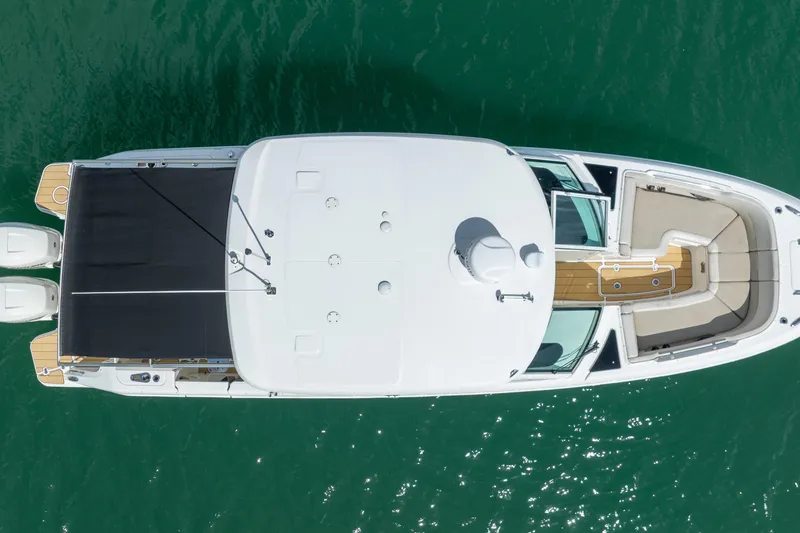 Slide: The Image of Overhead view of 2018 Boston Whaler 320 Vantage boat on clear water. - 11