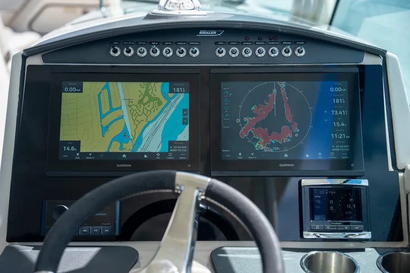 Slide: The Image of 2018 Boston Whaler 320 Vantage dashboard with Garmin navigation displays and steering wheel. - 13