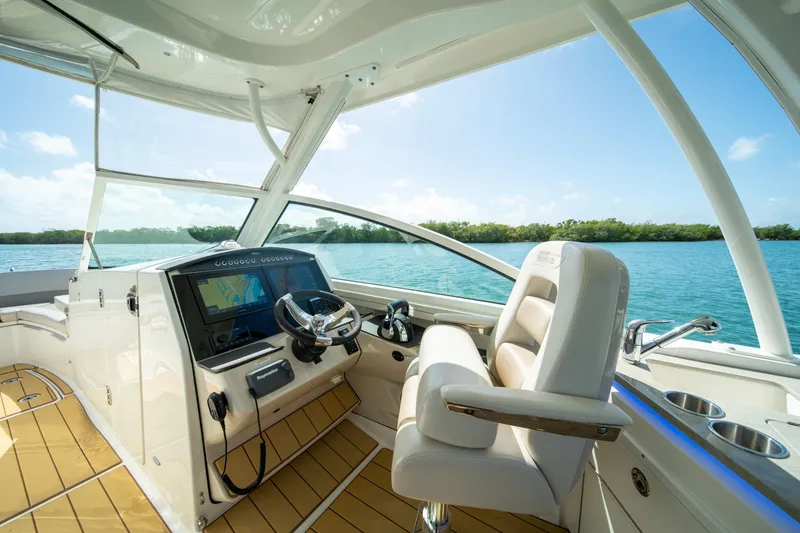 Slide: The Image of 2018 Boston Whaler 320 Vantage helm with luxurious seating and advanced navigation system. - 15