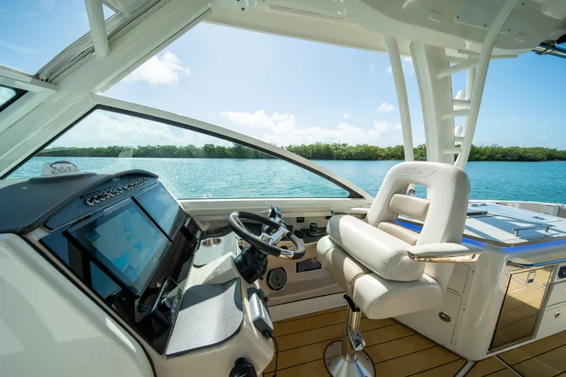 Slide: The Image of 2018 Boston Whaler 320 Vantage helm with luxurious seating and advanced navigation system. - 16