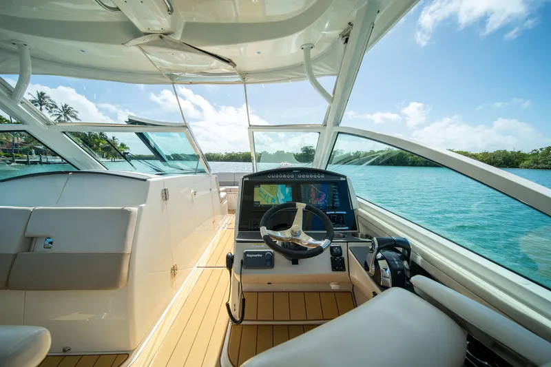 Slide: The Image of 2018 Boston Whaler 320 Vantage boat interior with steering wheel and navigation screens. - 17