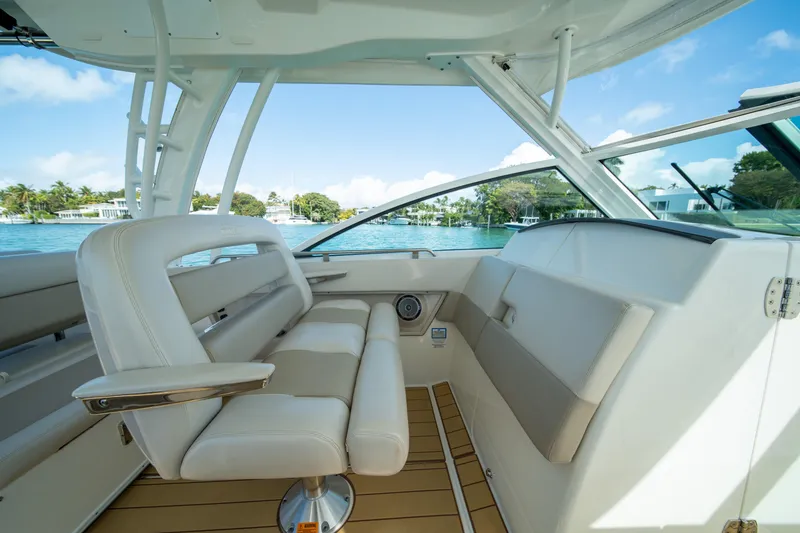 Slide: The Image of 2018 Boston Whaler 320 Vantage interior with luxurious seating and scenic water view. - 19