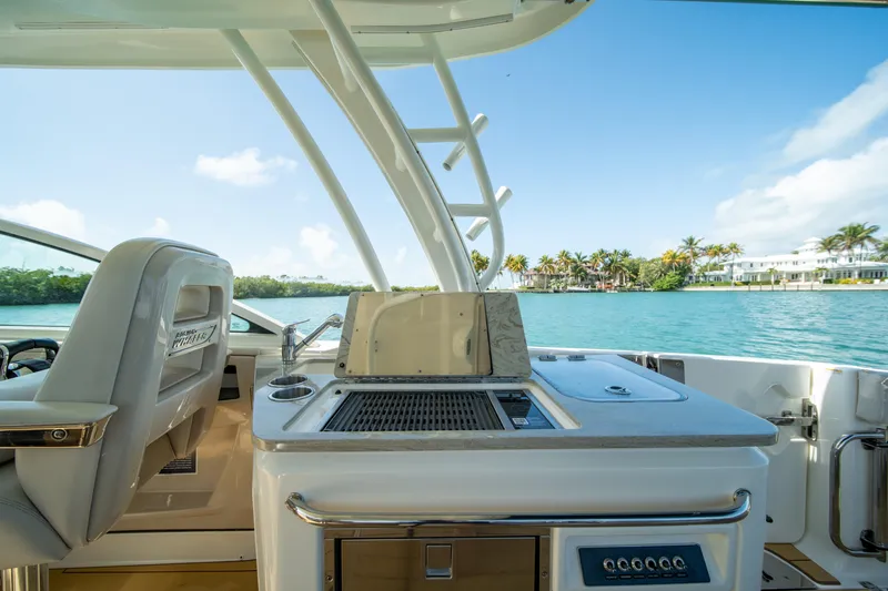 Slide: The Image of 2018 Boston Whaler 320 Vantage boat interior with ocean view and luxurious seating. - 26