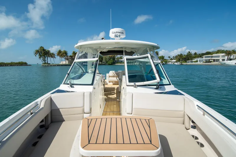 Slide: The Image of 2018 Boston Whaler 320 Vantage boat on serene water with clear blue sky. - 30
